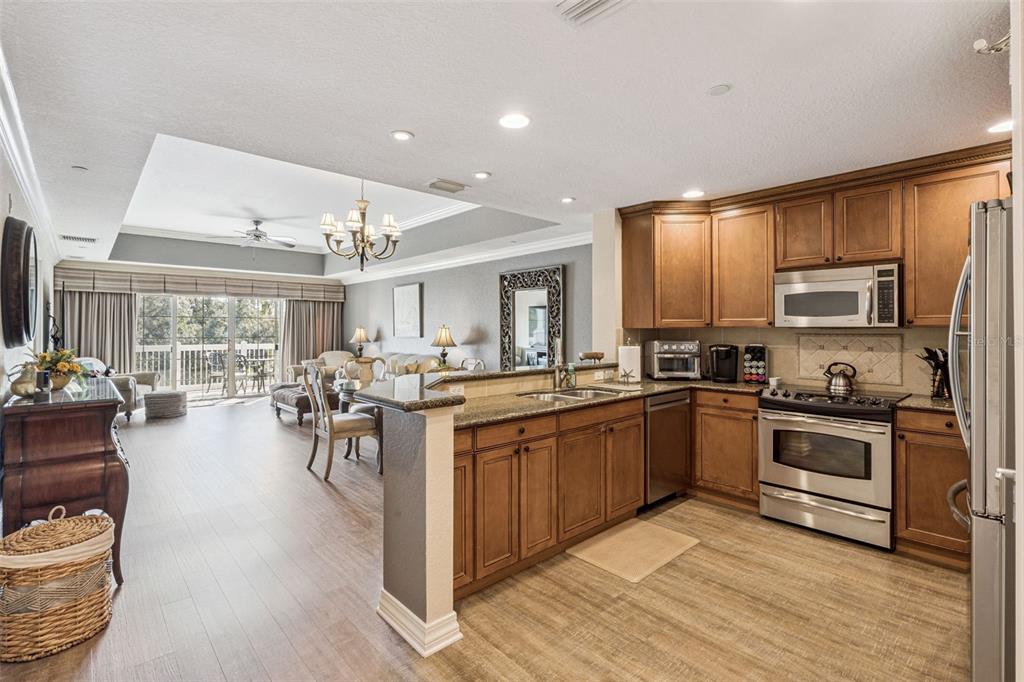 7656 Whisper Way, Unit 402 Reunion, FL 34747 - Photo 12 of 57 a kitchen with sink a stove and cabinets