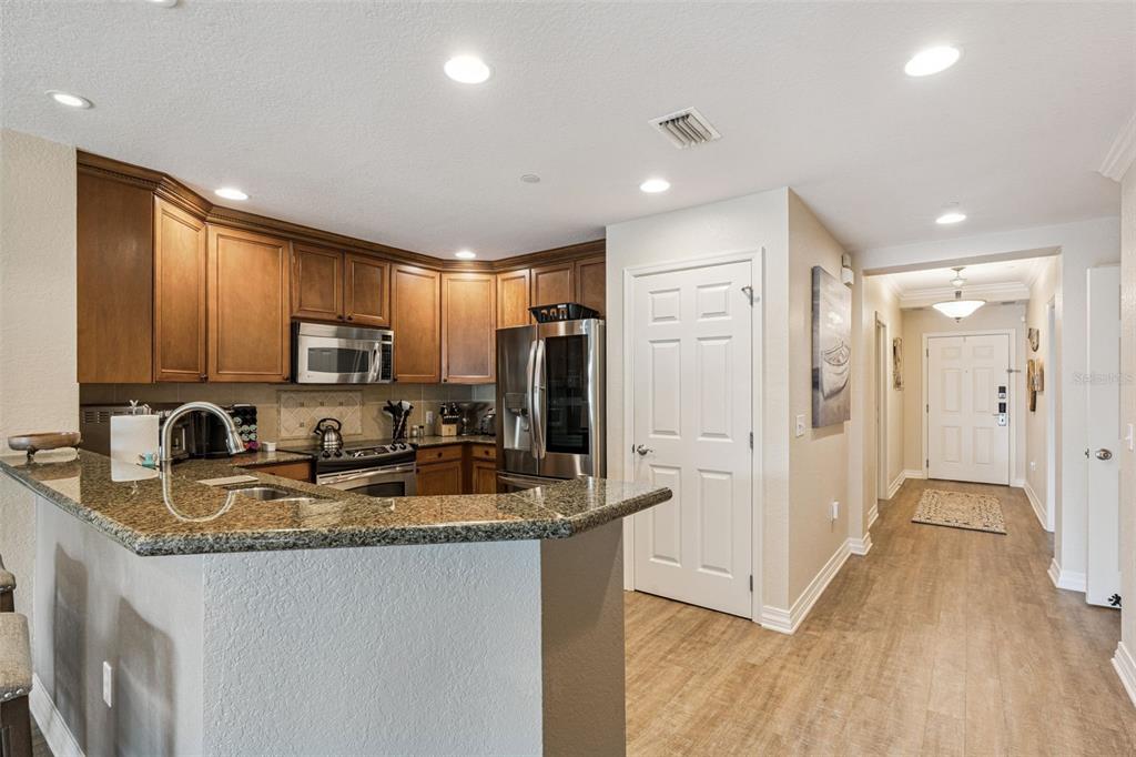 7656 Whisper Way, Unit 402 Reunion, FL 34747 - Photo 13 of 57 a kitchen with refrigerator cabinets and wooden floor