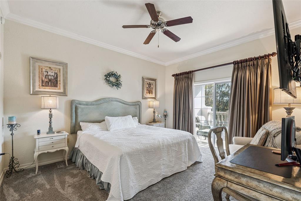 7656 Whisper Way, Unit 402 Reunion, FL 34747 - Photo 15 of 57 a bedroom with a bed and a large window