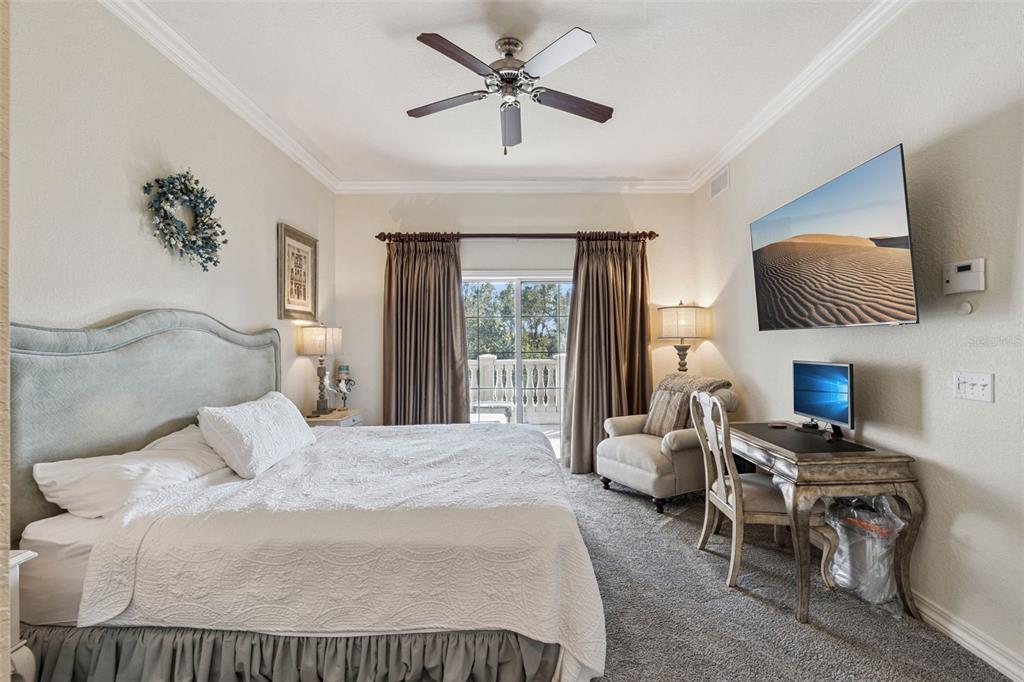 7656 Whisper Way, Unit 402 Reunion, FL 34747 - Photo 16 of 57 a bedroom with a bed and a chandelier