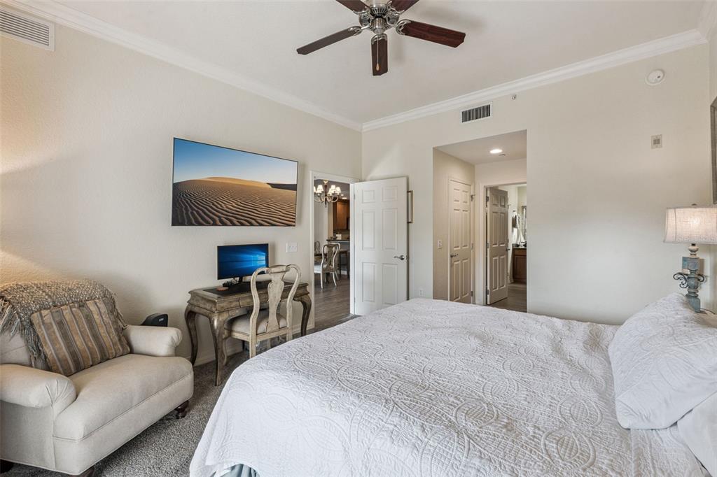 7656 Whisper Way, Unit 402 Reunion, FL 34747 - Photo 17 of 57 a bedroom with furniture and a flat screen tv