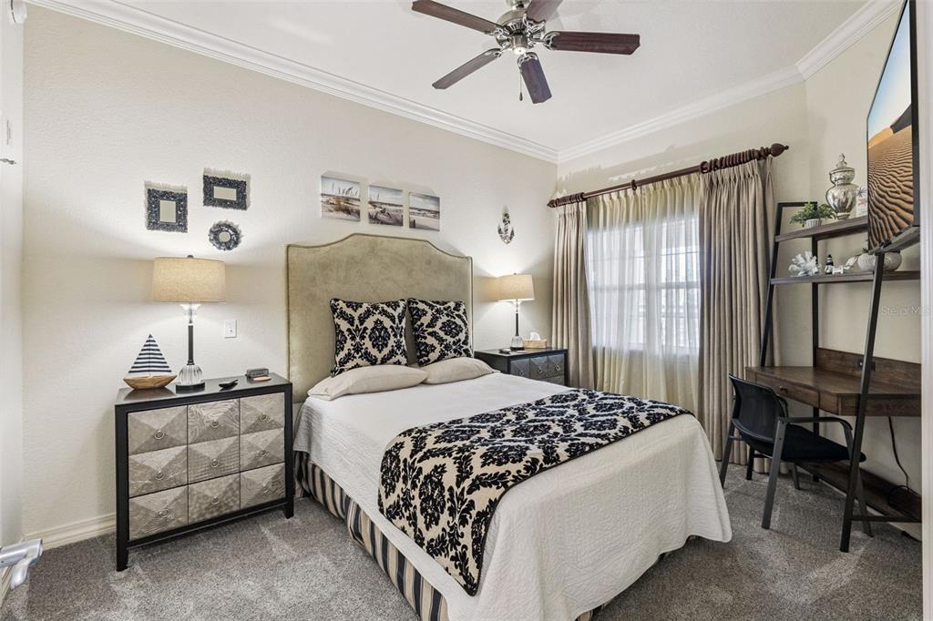 7656 Whisper Way, Unit 402 Reunion, FL 34747 - Photo 18 of 57 a bedroom with a bed and a chandelier