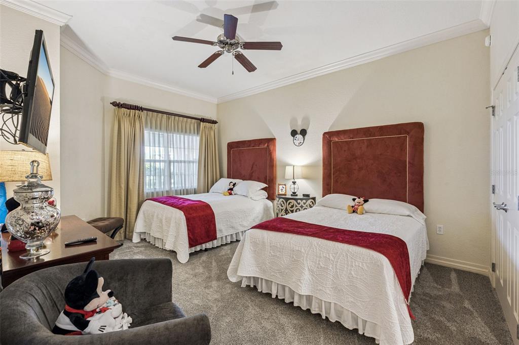 7656 Whisper Way, Unit 402 Reunion, FL 34747 - Photo 20 of 57 a bedroom with two beds and a window