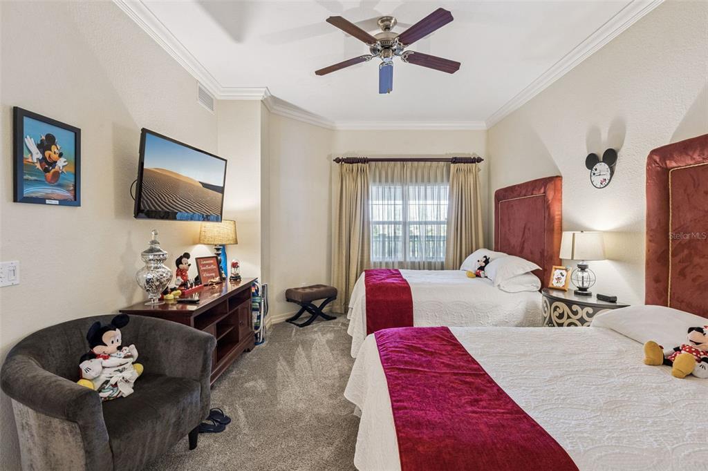 7656 Whisper Way, Unit 402 Reunion, FL 34747 - Photo 21 of 57 a bedroom with furniture and a flat screen tv