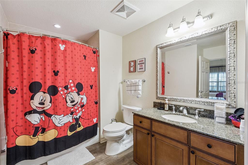 7656 Whisper Way, Unit 402 Reunion, FL 34747 - Photo 24 of 57 a bathroom with a sink vanity mirror and toilet
