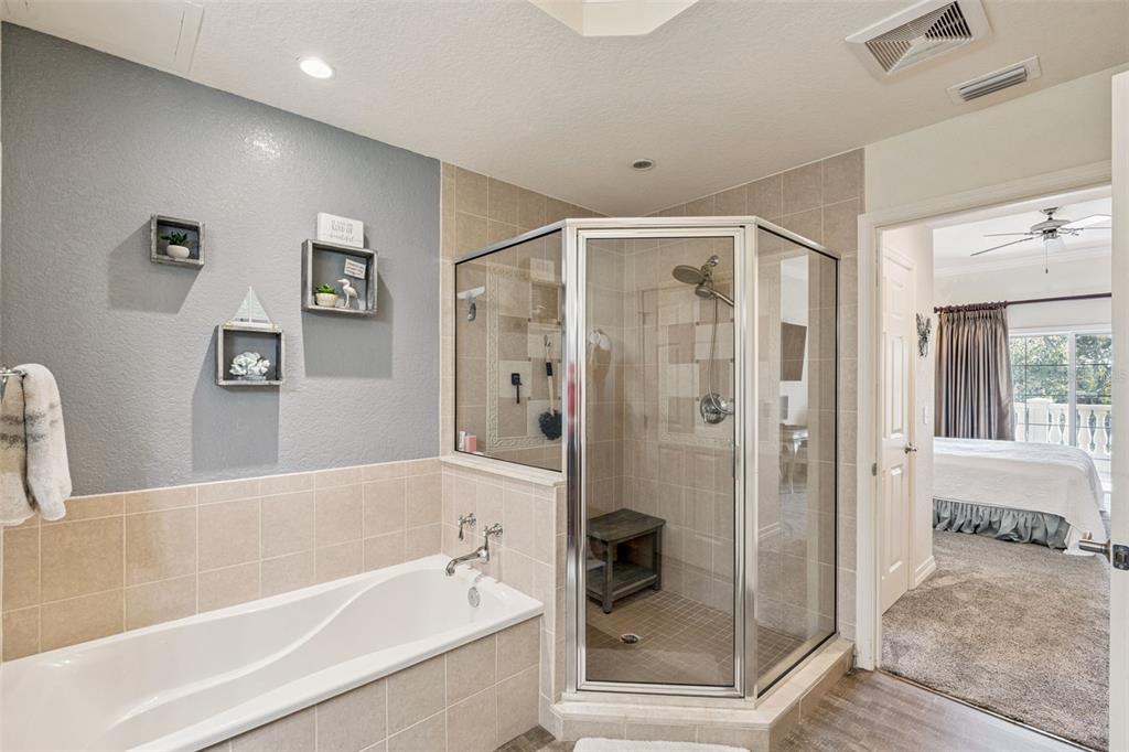 7656 Whisper Way, Unit 402 Reunion, FL 34747 - Photo 25 of 57 a bathroom with a bathtub and a shower