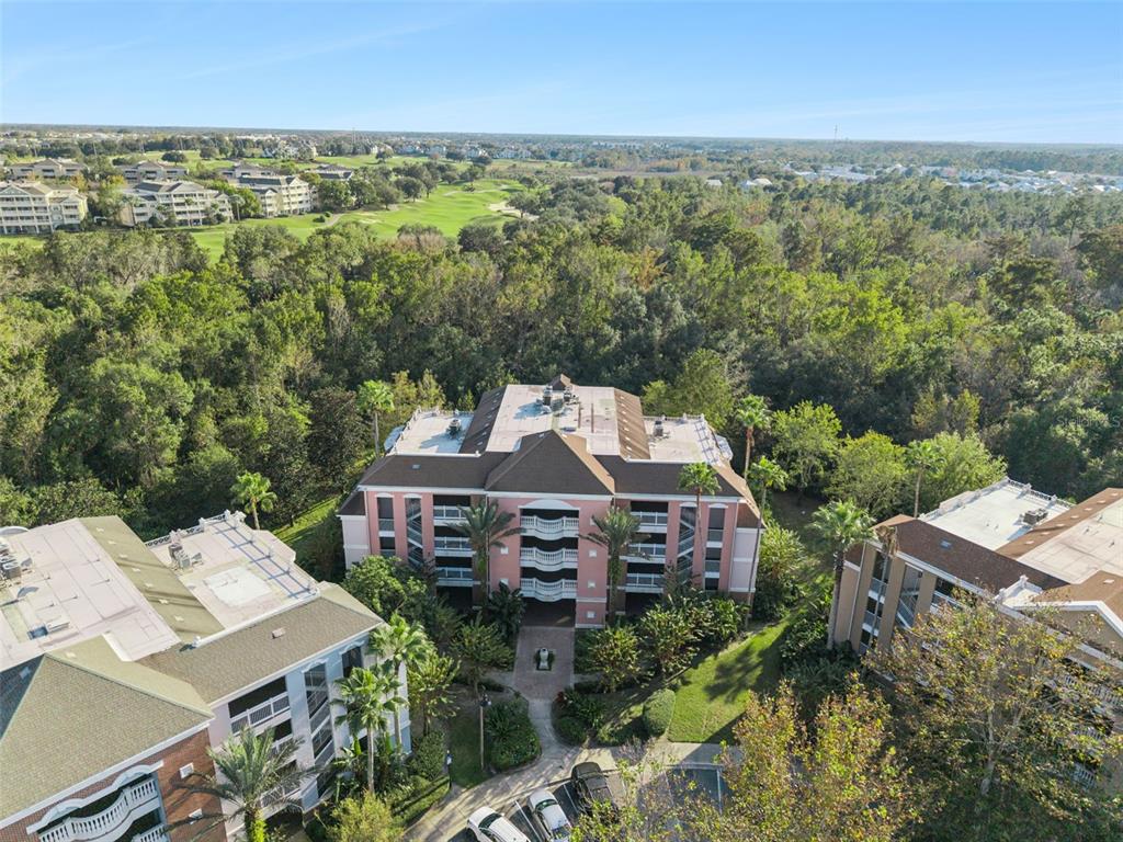 7656 Whisper Way, Unit 402 Reunion, FL 34747 - Photo 38 of 57 an aerial view of a house with a yard