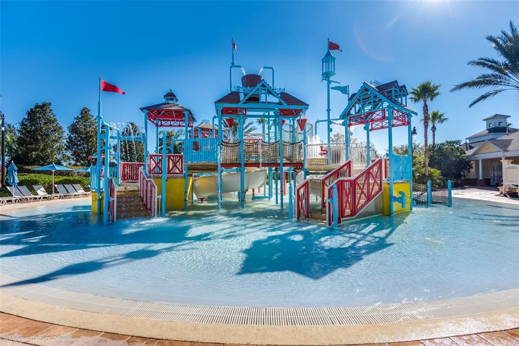 7656 Whisper Way, Unit 402 Reunion, FL 34747 - Photo 48 of 57 a view of a park with swings and slides