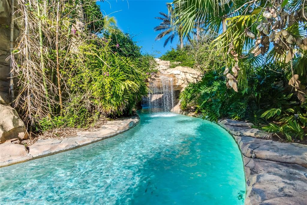 7656 Whisper Way, Unit 402 Reunion, FL 34747 - Photo 50 of 57 a view of a yard with plants and large trees