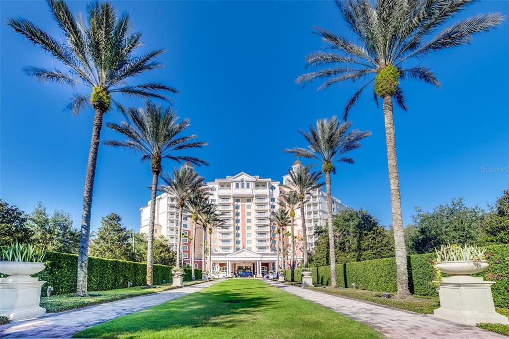 7656 Whisper Way, Unit 402 Reunion, FL 34747 - Photo 52 of 57 a view of a palm trees in front of a building