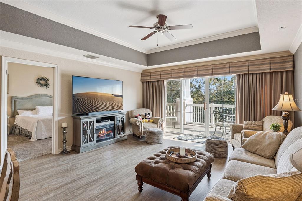 7656 Whisper Way, Unit 402 Reunion, FL 34747 - Photo 6 of 57 a living room with furniture and a flat screen tv
