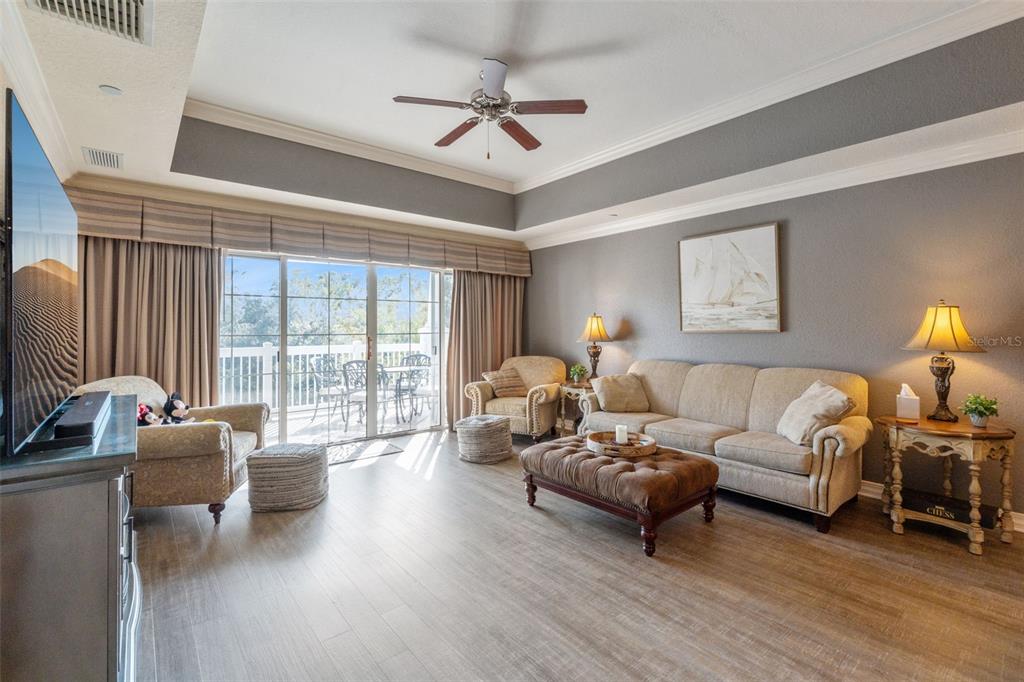 7656 Whisper Way, Unit 402 Reunion, FL 34747 - Photo 7 of 57 a living room with furniture ceiling fan and a window