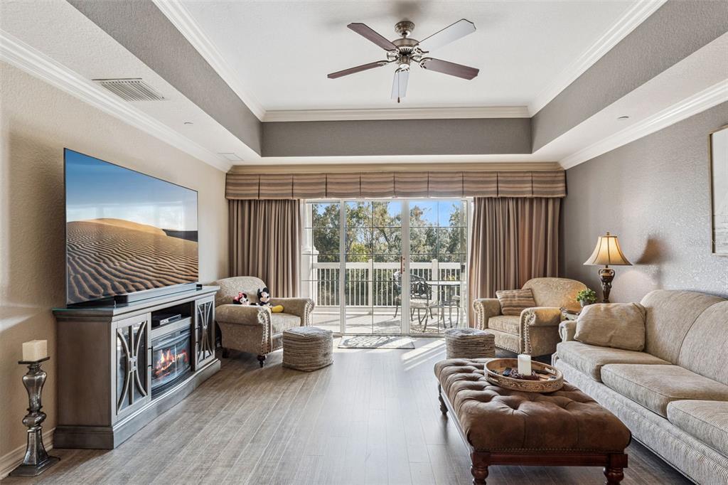 7656 Whisper Way, Unit 402 Reunion, FL 34747 - Photo 9 of 57 a living room with furniture and a window