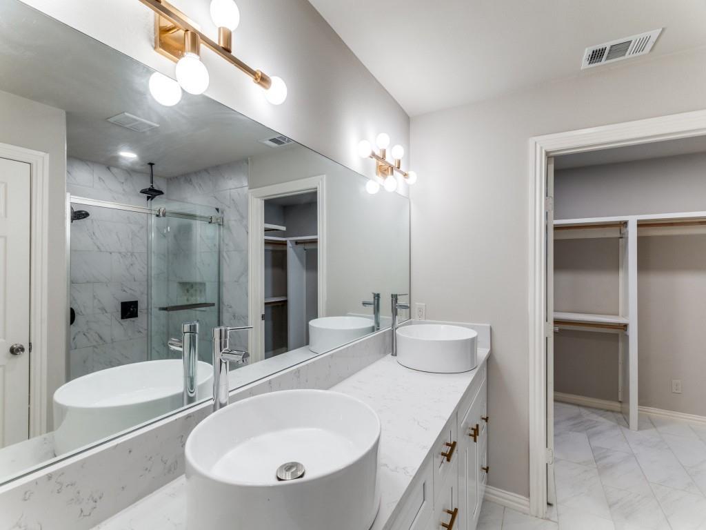 2001 Pebblebrook Trail Irving, TX 75060 - Photo 11 of 28 a bathroom with a granite countertop sink and a mirror