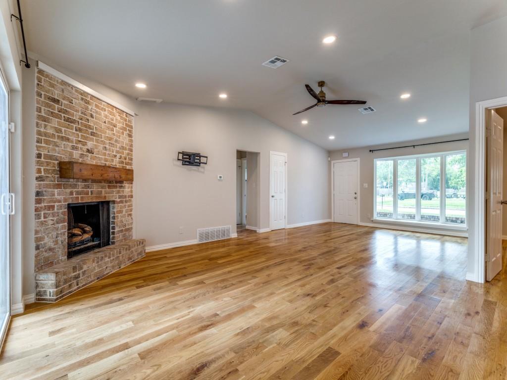 2001 Pebblebrook Trail Irving, TX 75060 - Photo 12 of 28 a view of an empty room with wooden floor and a fireplace