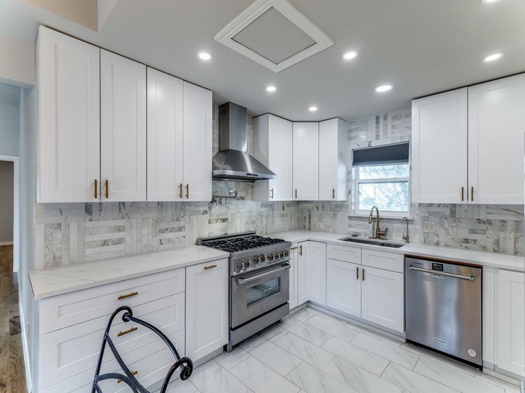 2001 Pebblebrook Trail Irving, TX 75060 - Photo 13 of 28 a kitchen with kitchen island granite countertop white cabinets stainless steel appliances and a sink
