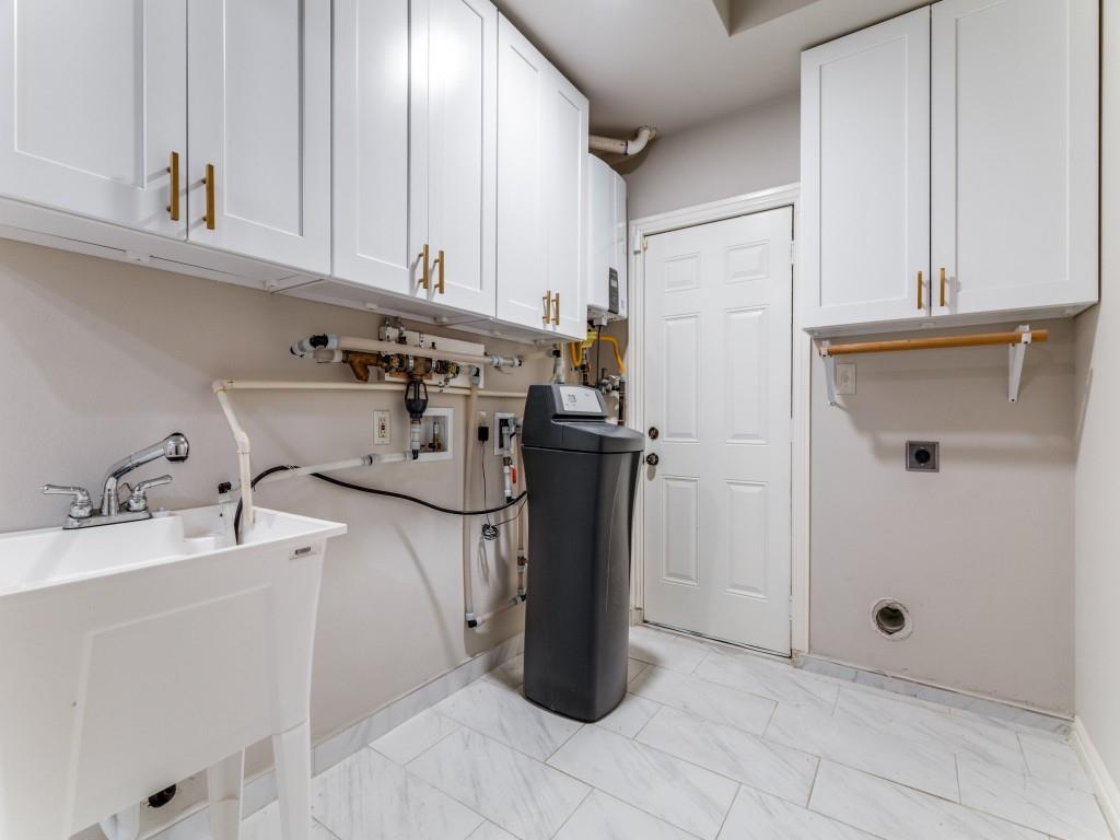 2001 Pebblebrook Trail Irving, TX 75060 - Photo 17 of 28 a kitchen with a refrigerator and cabinets