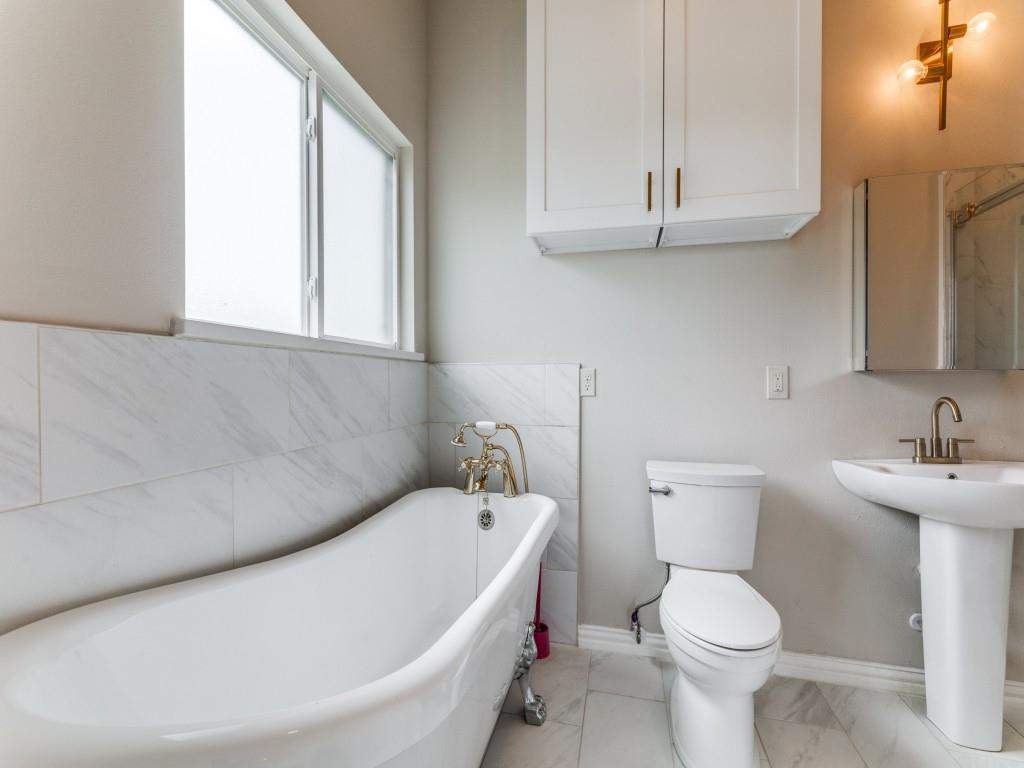 2001 Pebblebrook Trail Irving, TX 75060 - Photo 20 of 28 a white toilet sitting next to a bathroom sink