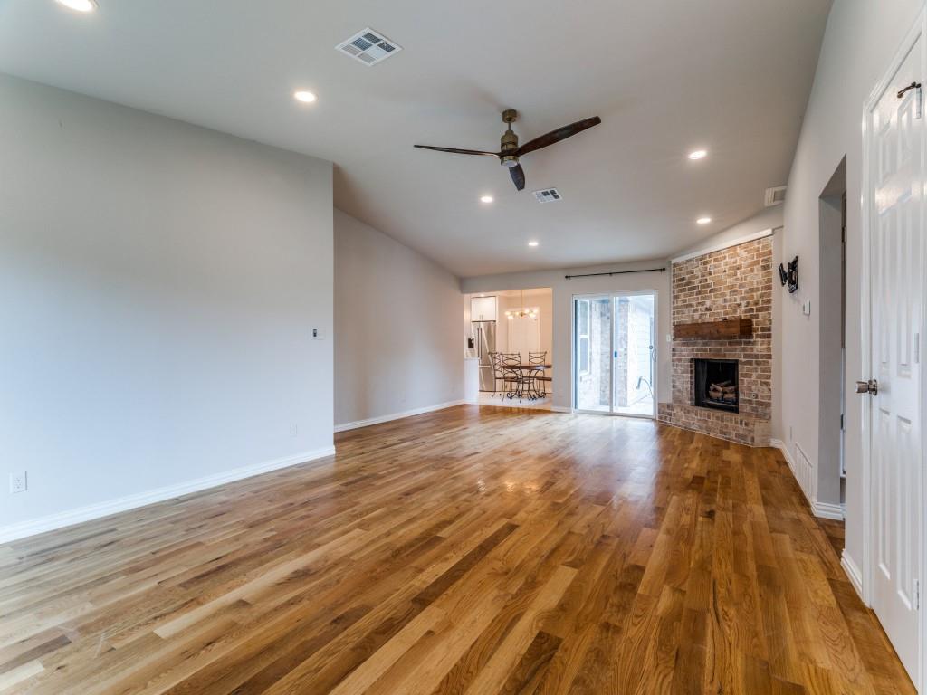 2001 Pebblebrook Trail Irving, TX 75060 - Photo 4 of 28 a view of empty room with wooden floor and fireplace