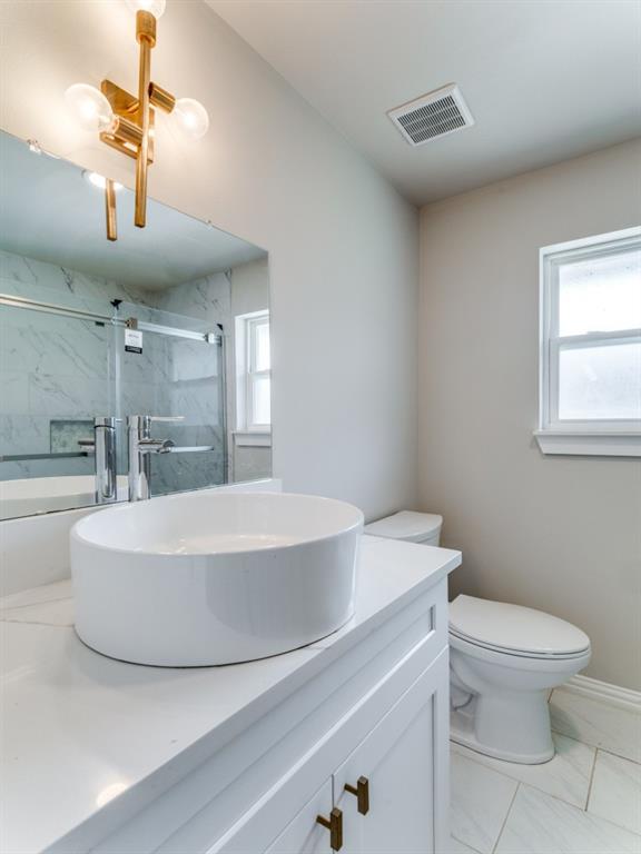2001 Pebblebrook Trail Irving, TX 75060 - Photo 7 of 28 a bathroom with a sink a toilet and a mirror