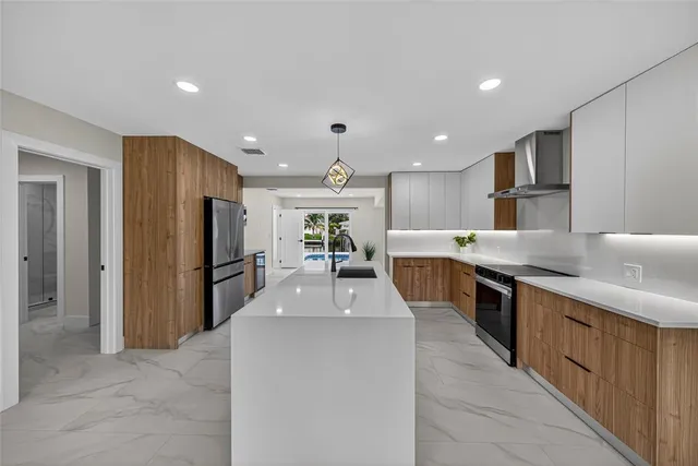 a kitchen with stainless steel appliances and refrigerator