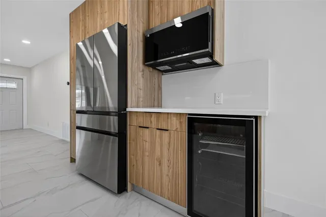 a kitchen with kitchen island a sink stainless steel appliances and cabinets