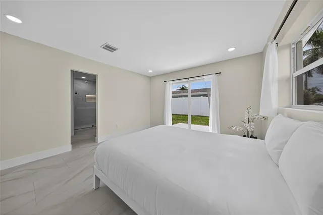 a large white bed in a white room