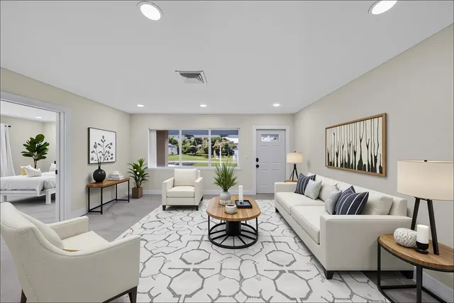 a large white kitchen with a large counter top stainless steel appliances and cabinets