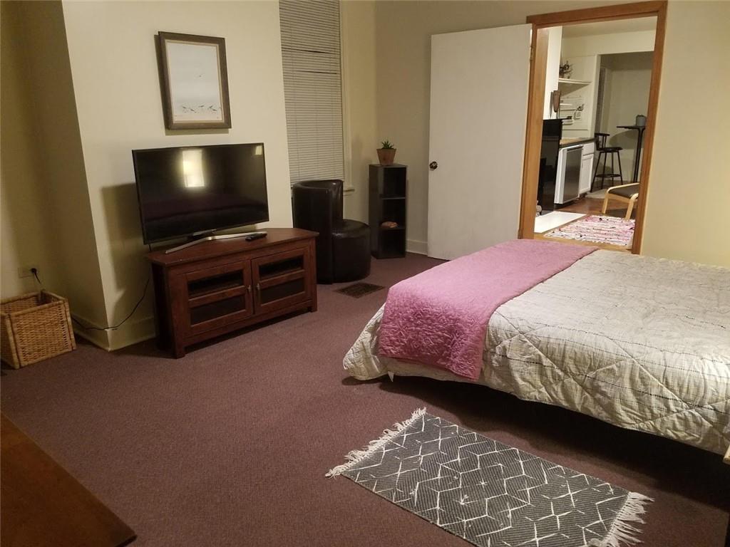 3235 Parkview Avenue Pittsburgh, PA 15213 - Photo 16 of 21 a bedroom with a bed and a flat screen tv