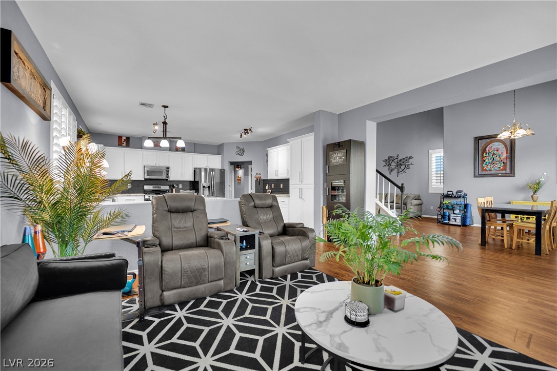 1724 Millstream Way Henderson, NV 89074 - Photo 60 of 60 An open floorplan seamlessly connects the kitchen, living room, and dining area, creating a spacious feel.