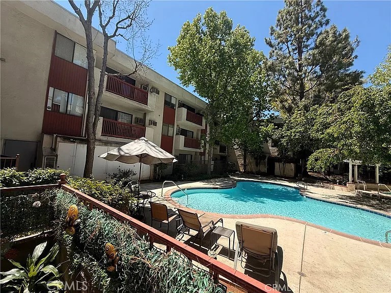 a view of a house with backyard and sitting area