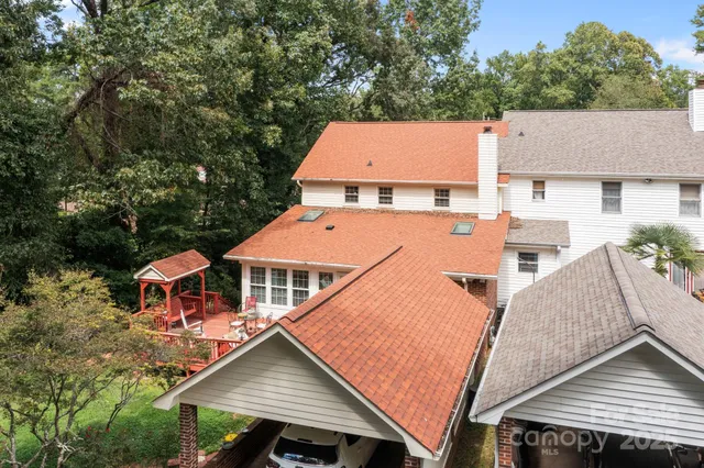an aerial view of a house with yard porch and furniture
