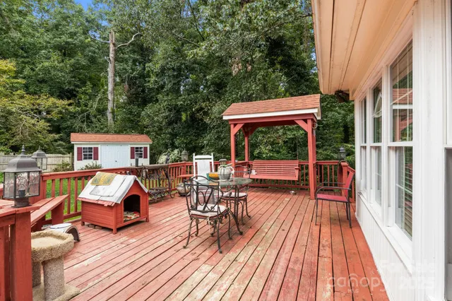 a view of house with deck outdoor seating and yard