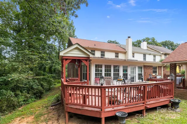 a view of a wooden deck with a yard