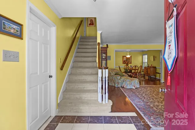 a view of a hallway with a dining table and chairs