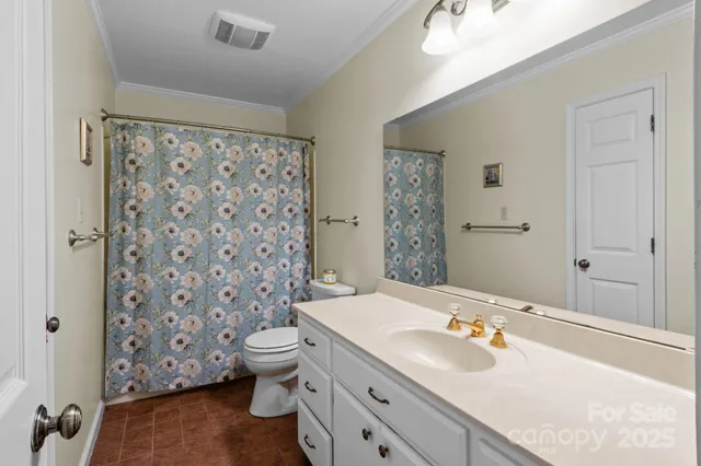 a kitchen with a refrigerator a stove and a dining table with wooden floor