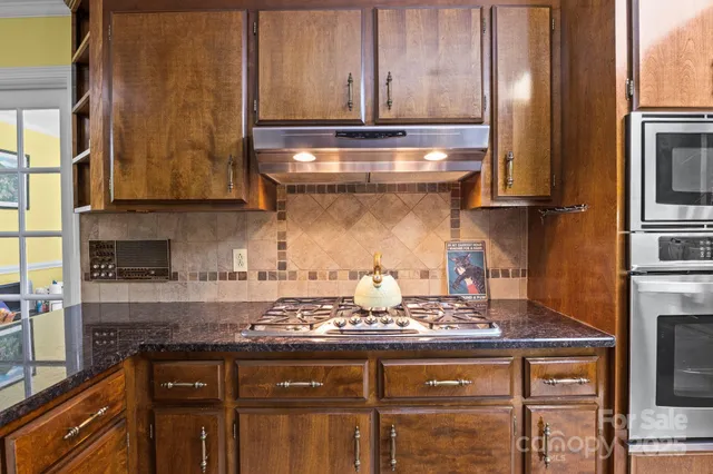 a kitchen with granite countertop a sink and a window