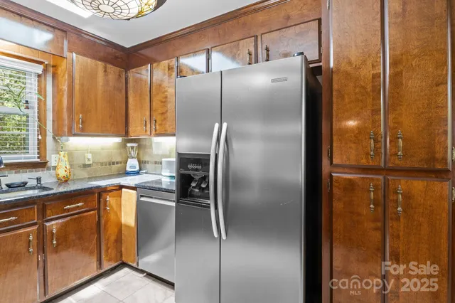 a kitchen with kitchen island granite countertop a stove and a sink