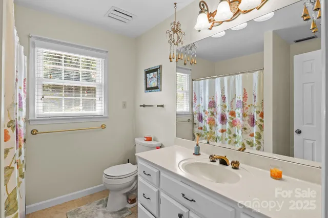 a bedroom with bed a lamp and a chandelier