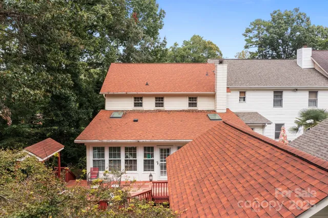 an aerial view of house with yard and trees in the background