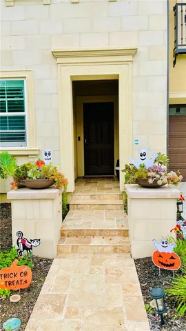 a front view of a house with an entrance and flowers