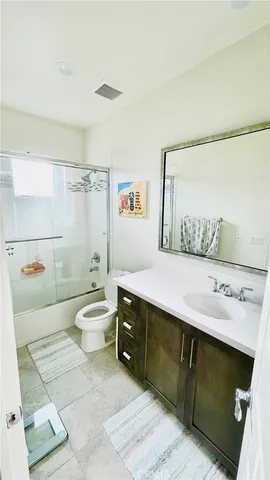 a bedroom with a bed and the view of bathroom