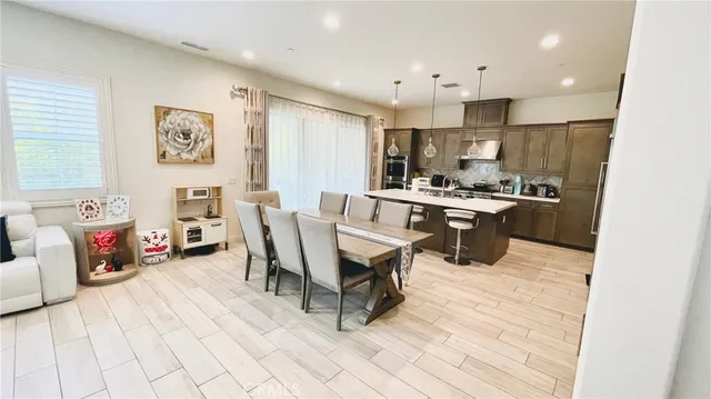 a large kitchen with a table and chairs