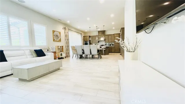 a kitchen with a table chairs and white kitchen