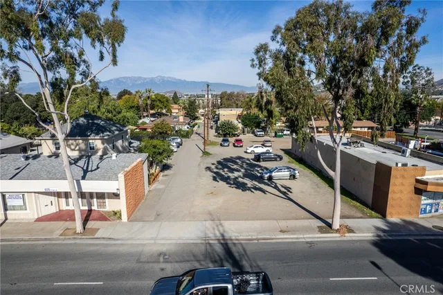 an aerial view of a house with a swimming pool yard and mountain view in back