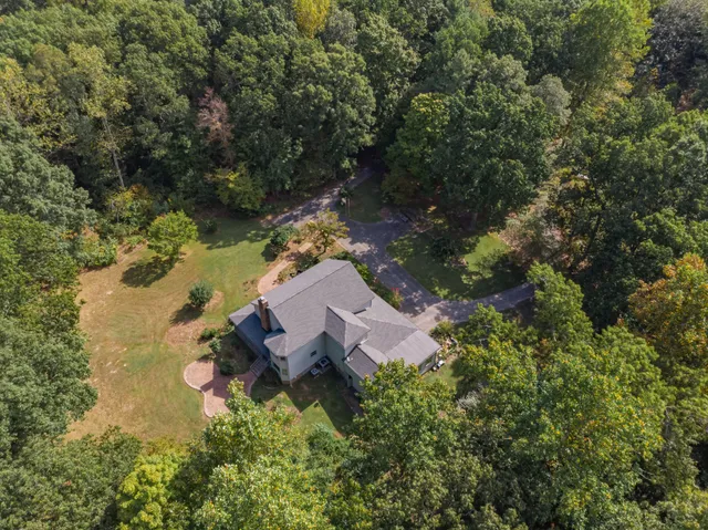 a living room with furniture and large windows