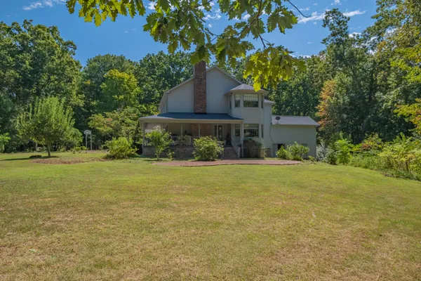 a kitchen with stainless steel appliances granite countertop a refrigerator a sink dishwasher a stove and white countertops with cabinets