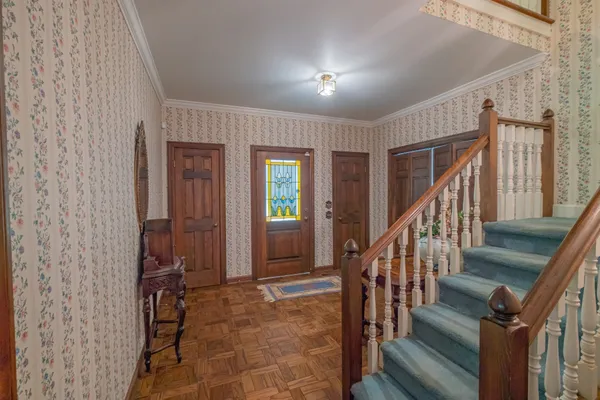a view of a dining room with furniture and chandelier