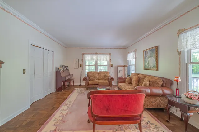 a spacious bedroom with a bed chandelier and a window