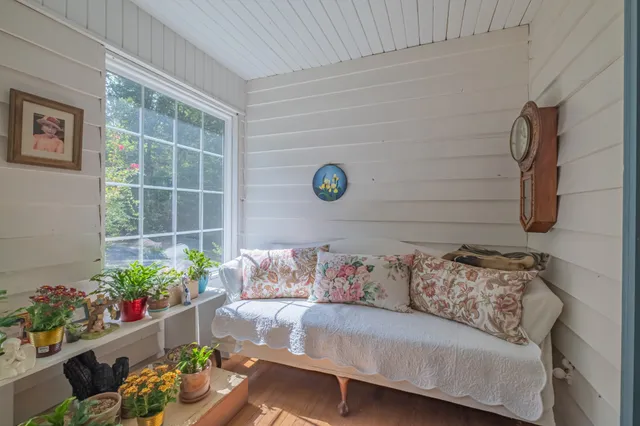 a white bath tub sitting next to a white sink and vanity